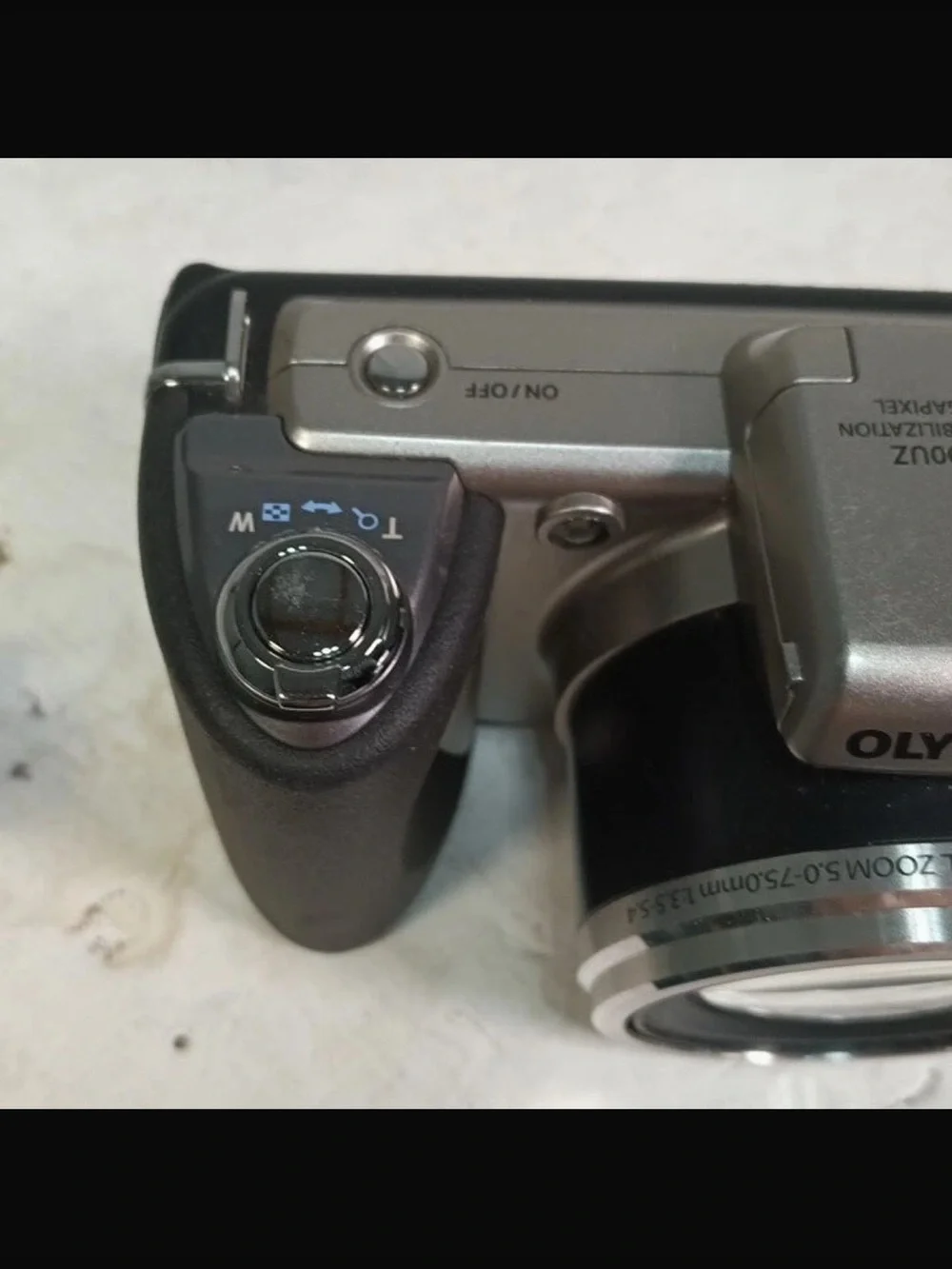 Olympus Silver Digital Camera with Black Grip and Lens Cap